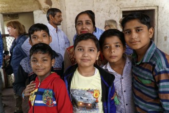 Red Fort, Agra, Uttar Pradesh, India, Group of children smiling friendly in a simple interior with