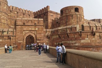Red Fort, Agra, Uttar Pradesh, India, Visitors standing on a pavement in front of a historic fort,
