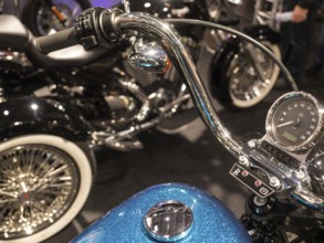 Retro motorbike handlebars with display and shiny chrome details on blue tank, dortmund, deutchland