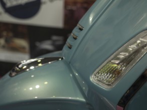 Close-up of a blue retro scooter with chrome accents and reflective surfaces, dortmund, deutchland