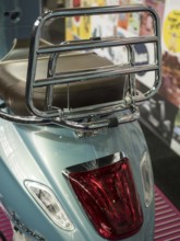 Blue scooter with chrome luggage rack and brown seat in retro design, dortmund, deutchland