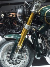Detailed view of a motorbike with gold-coloured suspension and green fairing, dortmund, deutchland