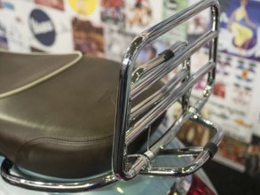 Brown motorbike seat with chrome luggage rack in front of colourful wall, dortmund, deutchland