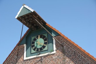 A large clock on a brick building under a clear sky, südlohn, westphalia, germany
