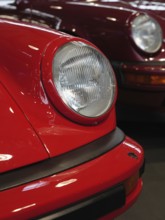 Red Porsche in focus, emphasises the front and headlights, shows classic style, Cologne, Germany