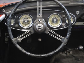A stylish steering wheel in a classic car, featuring a retro feel and classic instruments, Cologne,