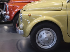 Side view of yellow and red vintage cars arranged in an exhibition, Cologne, Germany