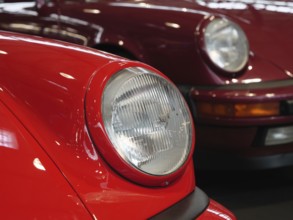 Front view of two classic red Porsches, showing elegant style, Cologne, Germany