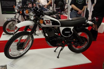 Retro motorbike on display with black and white colour design, ready for off-road adventures,