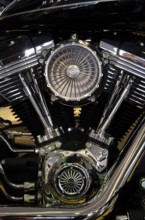 Close-up of a shiny chrome motorbike engine, emphasising the technical precision and robust style,