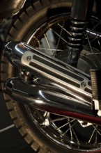 Close-up of a chrome exhaust and tyre of a retro-style motorbike, dortmund, germany