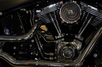 Close-up of a shiny motorbike engine block with visible valves and fan, dortmund, germany