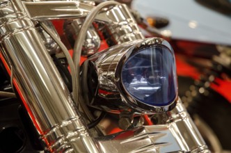 Close-up of a blue motorbike headlight in chrome with modern lines, dortmund, germany