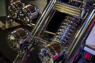 Front view of a motorbike with several shiny chrome headlights and suspension fork, dortmund,