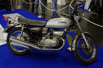 Retro Suzuki motorbike GT550 in blue with chrome details exhibited at a fair, dortmund, germany
