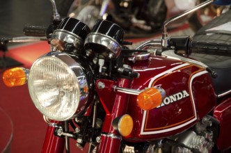 Red Honda motorbike in retro style with headlights at a trade fair, dortmund, germany