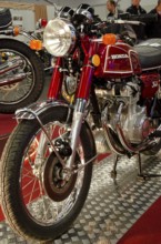 Classic red Honda motorbike with lots of chrome elements in a showroom, dortmund, germany