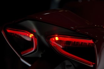 Red tail lights of a motorbike in dark surroundings, modern design, dortmund, germany