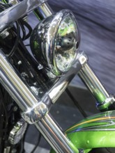 Motorbike headlight with green details and shiny chrome, dortmund, germany