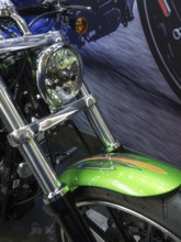 Motorbike with green and chrome accents riding down a street, dortmund, germany