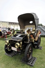 Black and gold classic car with nostalgic retro style, presented at a car exhibition, Retro