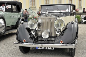 Vintage car in black and cream with dominant front grille and headlights, Retro Classics meets
