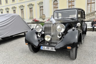Shiny black classic car in limousine style in front of a historic building, Retro Classics meets