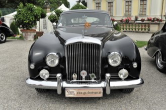 Shiny black Bentley classic car with striking headlights and classic front, Retro Classics meets