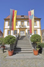Baroque town hall built in 1739 with German national flag and town flag, open staircase, entrance,