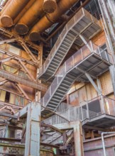Low angle rusty industrial scenery with old corroded steel girders and metal tubes