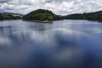 A large reservoir (Aggertalsperre) under a cloudy sky with green wooded banks, Bergneustadt