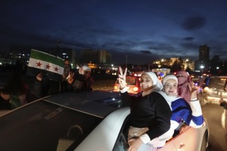 Thousands of Syrians take to public squares and main streets waving the revolutionary flag and