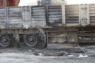 Burned trucks are seen in the opposition-held city of Azaz following shelling by forces loyal to