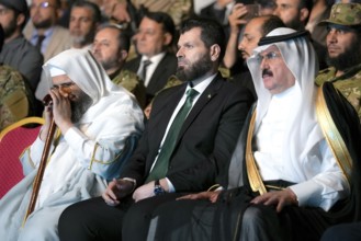 Officials of the new Syrian government take part in a public celebration following the fall of
