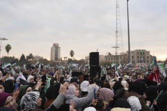 Thousands of Syrians take to public squares and main streets waving the revolutionary flag and