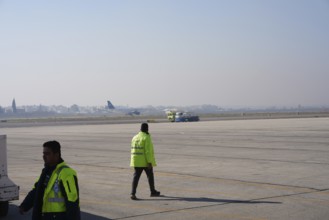 Passengers celebrate with Syrian revolutionary flags as the first flight lands at Aleppo