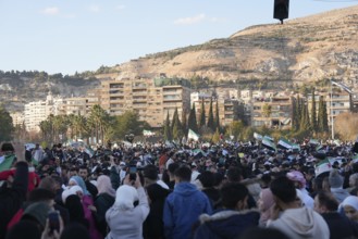 Thousands of Syrians take to public squares and main streets waving the revolutionary flag and