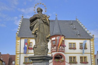 Madonna figure at the market fountain, Renaissance town hall with town flag, Bavarian state flag