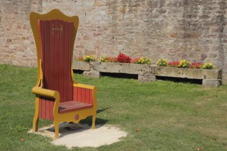 Red golden throne in the inner courtyard, garden, museum, Brothers Grimm House, Steinau an der