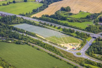 Aerial view, field with construction site for ground-mounted photovoltaic plant solar park at the