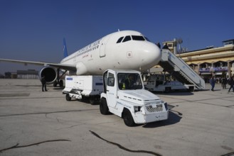 Passengers celebrate with Syrian revolutionary flags as the first flight lands at Aleppo