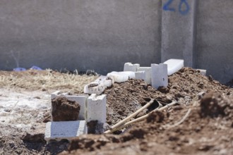 View shows a grave covered with blocks of snow in a cemetery. Azaz, Syria. July 3, 2024, Aleppo,