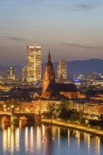 Illuminated Frankfurt Cathedral, Residential Buildings, City and Main River at Night. Aerial View.