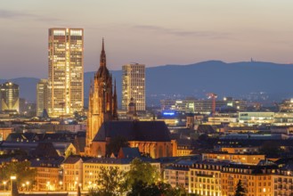 Illuminated Frankfurt Cathedral, Residential Buildings and City at Night. Aerial View. Blue Hour.