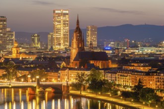 Illuminated Frankfurt Cathedral, Residential Buildings, City and Main River at Night. Aerial View.