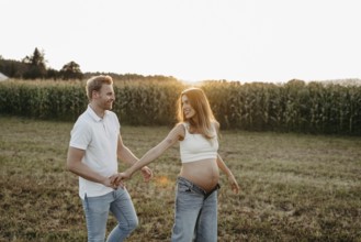 Pregnant, young woman with partner