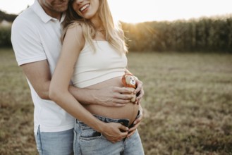 Pregnant, young woman with partner