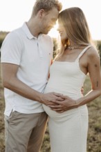 Pregnant, young woman with partner