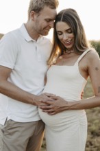 Pregnant, young woman with partner