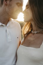 Young couple in love, nose to nose in front of the sunset